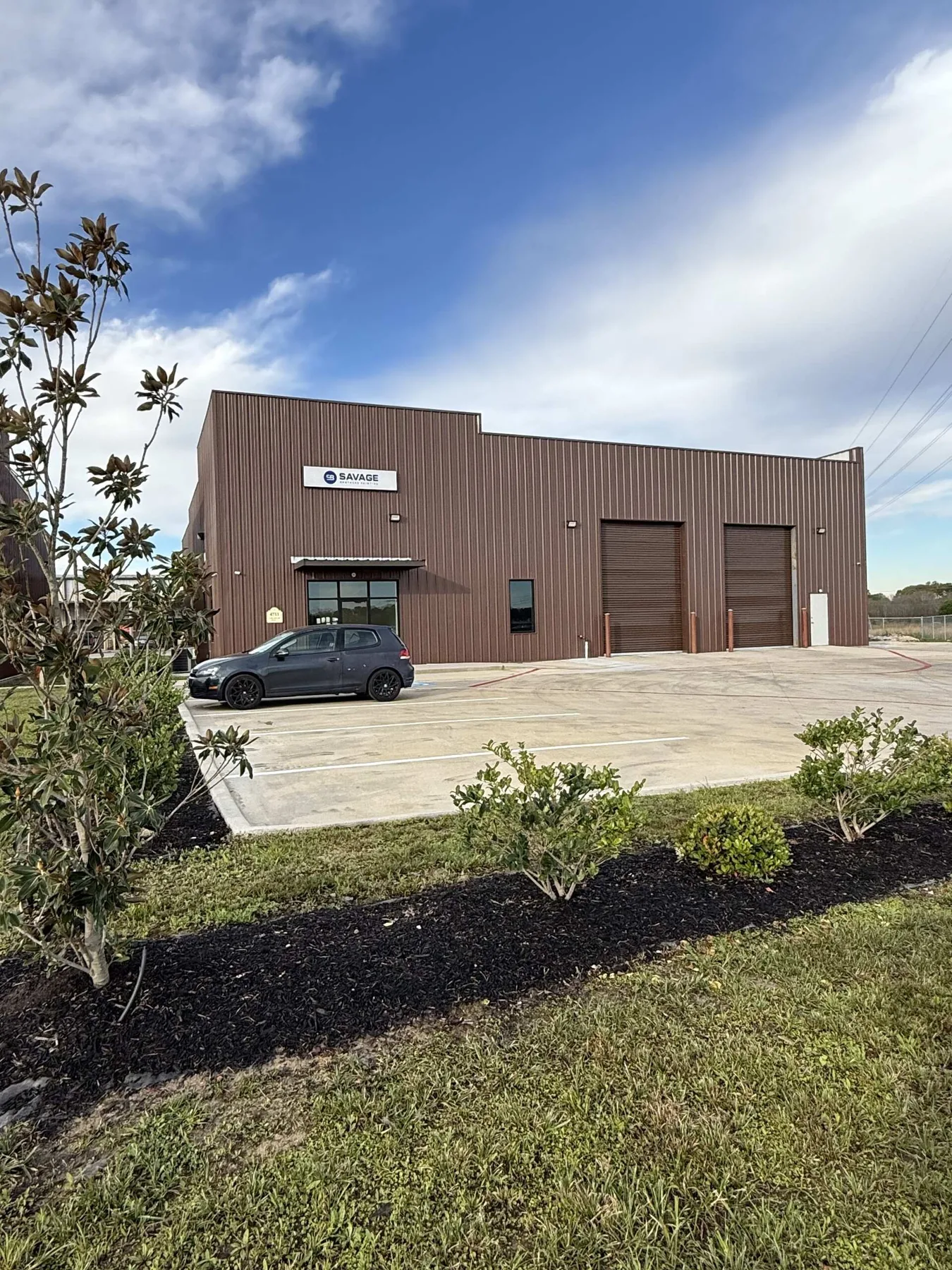 Completed industrial tenant entrance with service bay